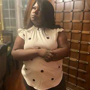 White ruffle short sleeve blouse. Polka dots. Two buttons in back at neck.